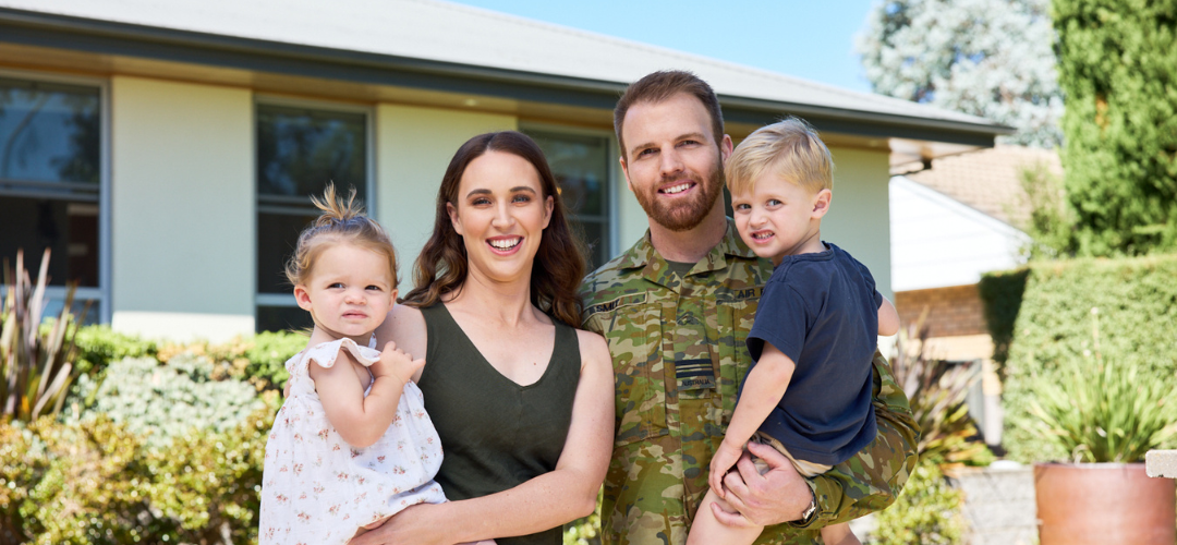 Defence member photo in front of house with family 2024